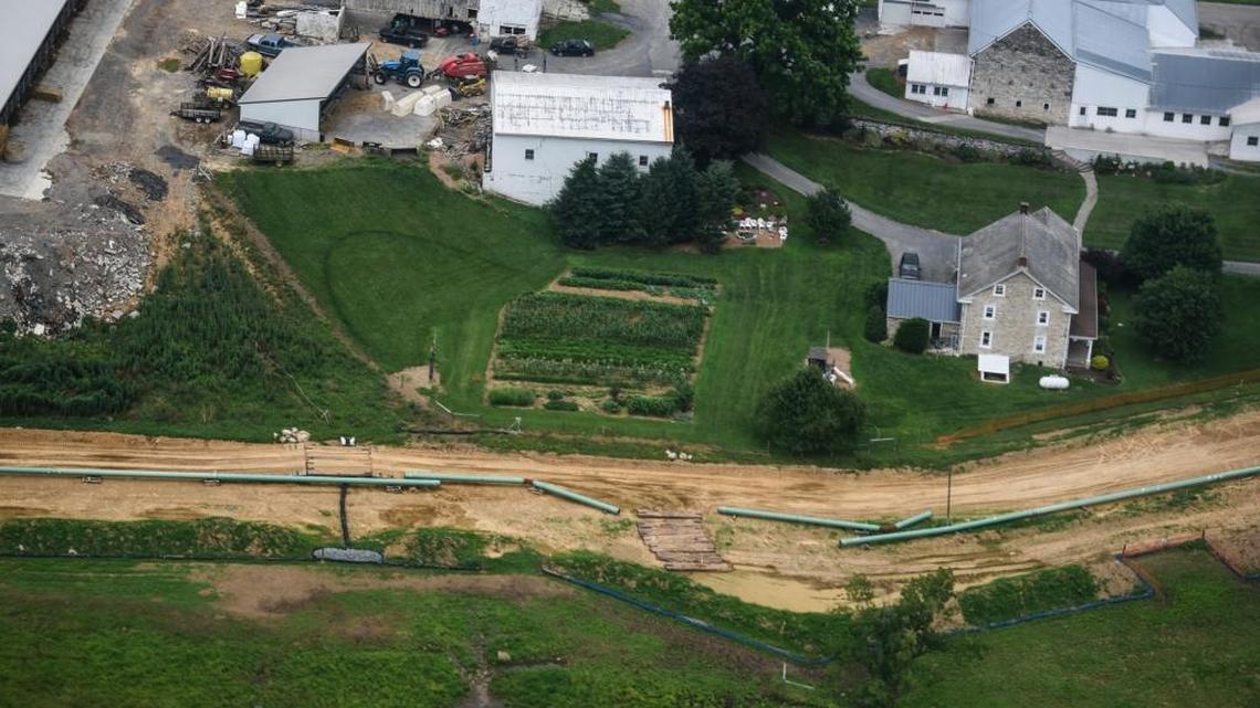 Pipes for the Sunoco Mariner East pipeline sit next to a farm in South Lebanon Township, Pa., on July 5. Sunoco is paying to connect municipal water to about 30 Pennsylvania households whose wells were contaminated by the pipeline construction. Several other pipelines - many designed to carry natural gas from West Virginia and surrounding states - are in the works, awaiting federal approval.