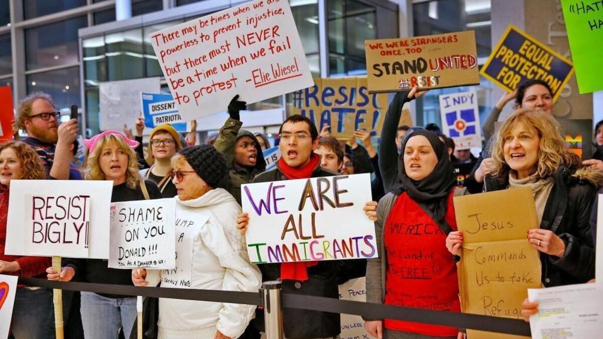 People chant slogans at the Indianapolis International Airport, Sunday, Jan. 29, 2017, during a protest against President Donald Trump’s executive order temporarily suspending all immigration for citizens of seven majority Muslim countries for 90 days.