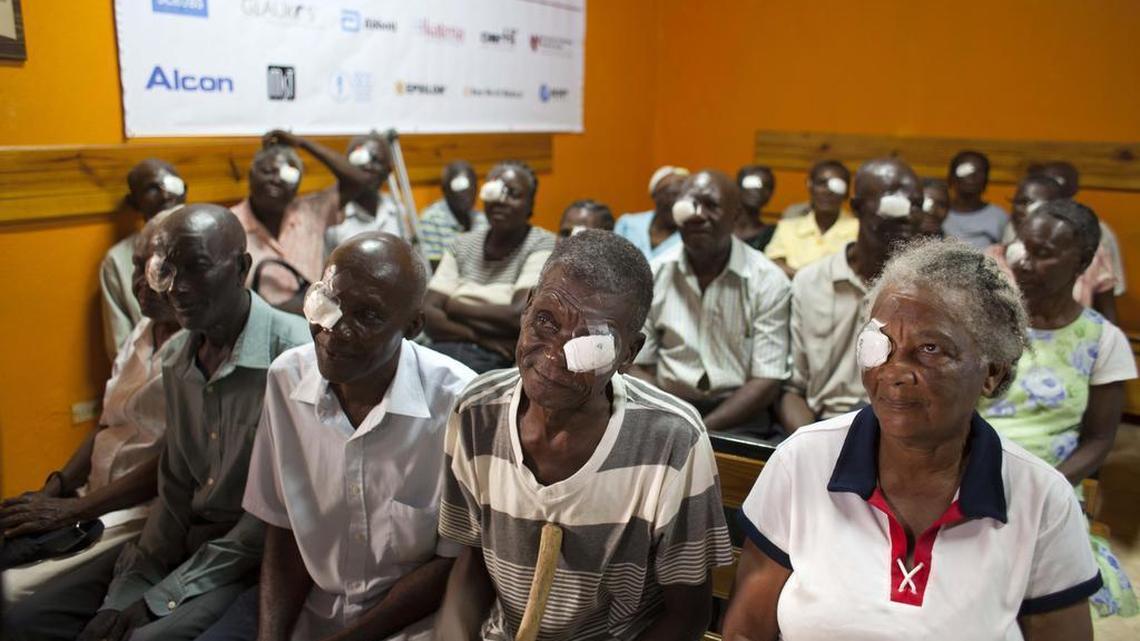
Mathieux Saint Fleur, 75, second from right, sits in a clinic on Aug. 18, 2015, with other patients who had cataracts removed as they wait to have their bandages removed one day after surgery in Cap-Haitien, Haiti. After the white gauze was peeled away, Saint Fleur was speechless for a few moments. “I see! I see!” he said, joy spreading across his face.
