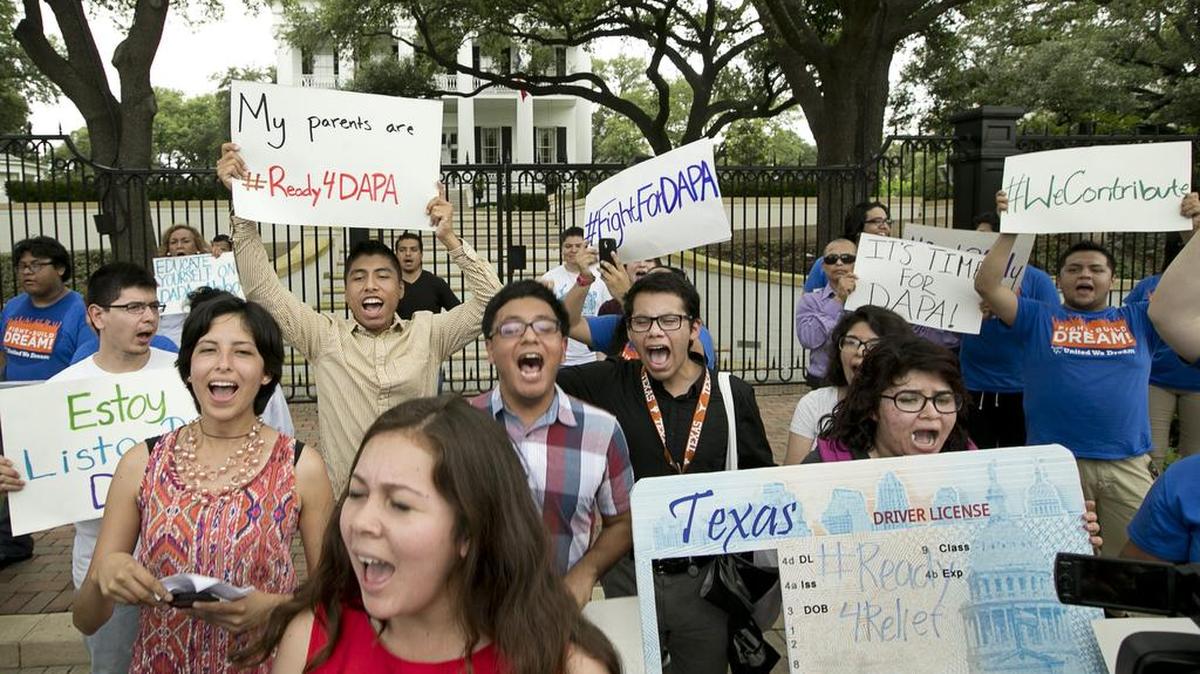 Immigrant rights activists chant outside the Governor's Mansion in Austin, Texas, on Tuesday May 19, 2015, to protest the Texas lawsuit against the Deferred Action for Parents of Americans, also known as DAPA, which would have gone into effect today. (Jay Janner/Austin American-Statesman/TNS)
