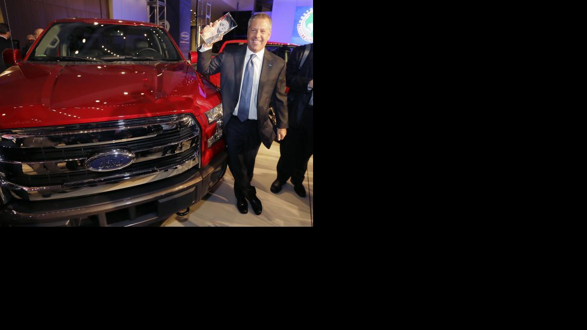 
Joe Hinrichs, Ford executive vice president and president, the Americas, poses with the Ford F-150 truck after winning the North American Truck of the Year during the North American International Auto Show, Monday, Jan. 12, 2015, in Detroit.
