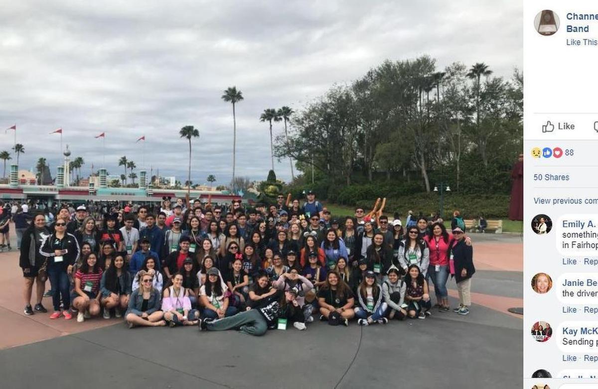 Students from a group trip to Disney World pose for a photo outside Disney World Monday.