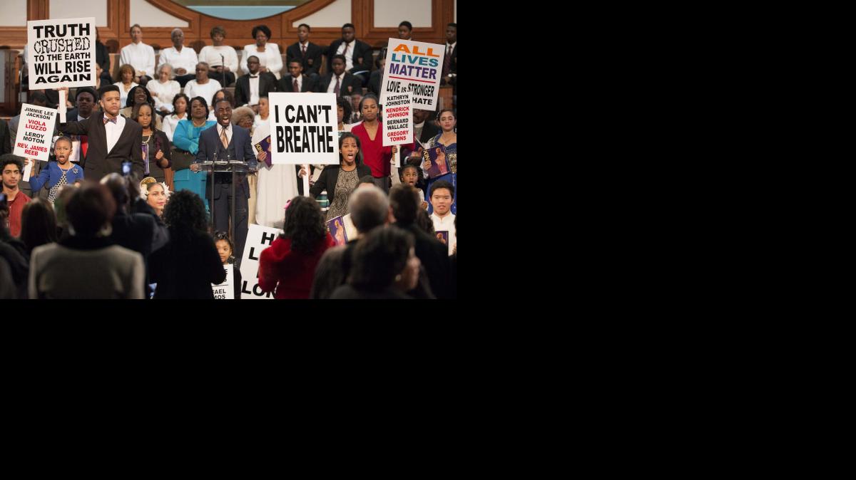 
People hold up signs as part of a performance during the Rev. Martin Luther King Jr. holiday commemorative service at Ebenezer Baptist Church, the church where King preached, Monday, Jan. 19, 2015, in Atlanta. (AP Photo/David Goldman)
