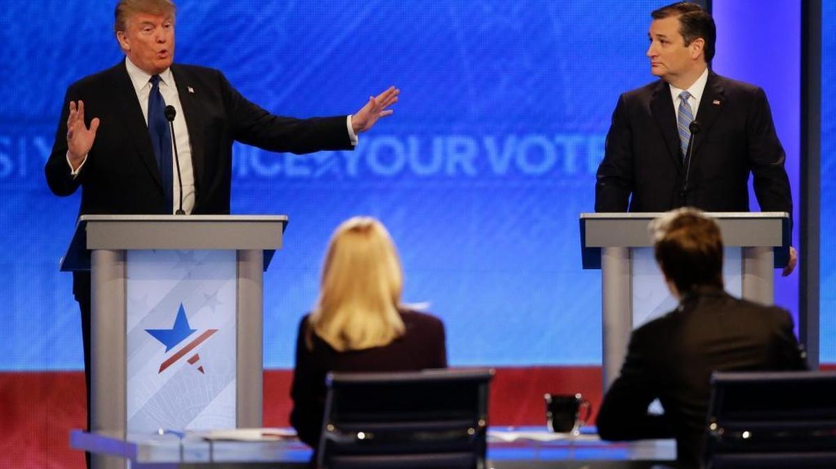 Donald Trump answers a question as Sen. Ted Cruz of Texas listens.