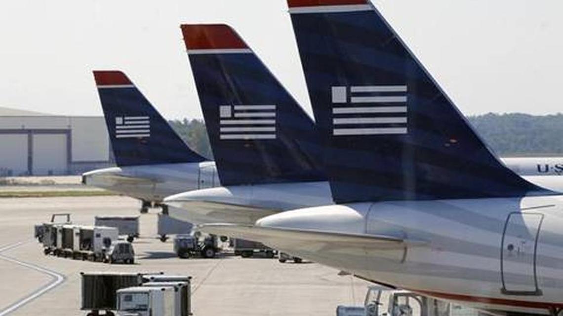 US Airways jets are shown parked at their gates at the Charlotte-Douglas International Airport. Under a bill approved by the House on Tuesday, newly-hired veterans working for the Federal Aviation Administration could soon qualify for paid sick leave, if their disability rating exceeds 30 percent.