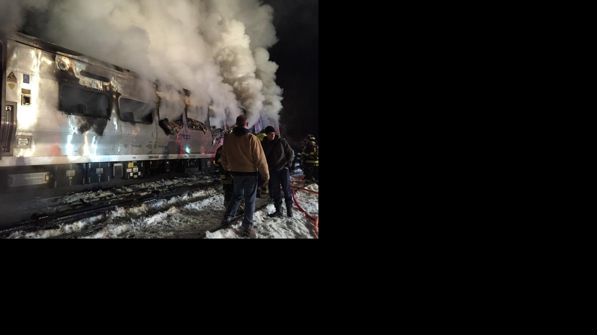 
A Metro-North Railroad passenger train smolders after hitting a vehicle in Valhalla, N.Y., Tuesday, Feb. 3, 2015. 
