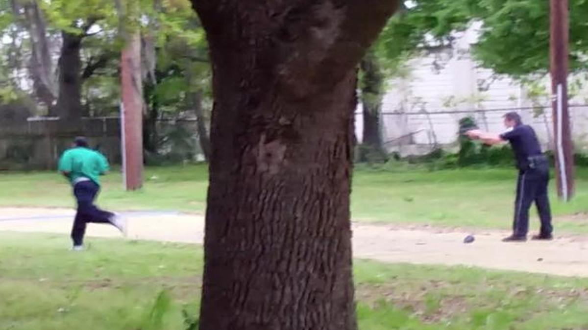 
In this April 4, 2015, frame from video provided by Attorney L. Chris Stewart representing the family of Walter Lamer Scott, Scott runs away from city patrolman Michael Thomas Slager, right, in North Charleston, S.C. Slager was charged with murder on Tuesday, April 7, hours after law enforcement officials viewed the dramatic video that appears to show him shooting a fleeing Scott several times in the back. 
