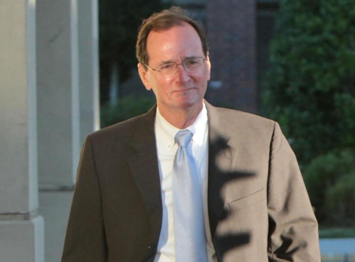 Former Department of Marine Resources Director Bill Walker arrives at the FBI office in Gulfport on Friday, Nov. 8, 2013, after being indicted on charges related to his work at the agency.