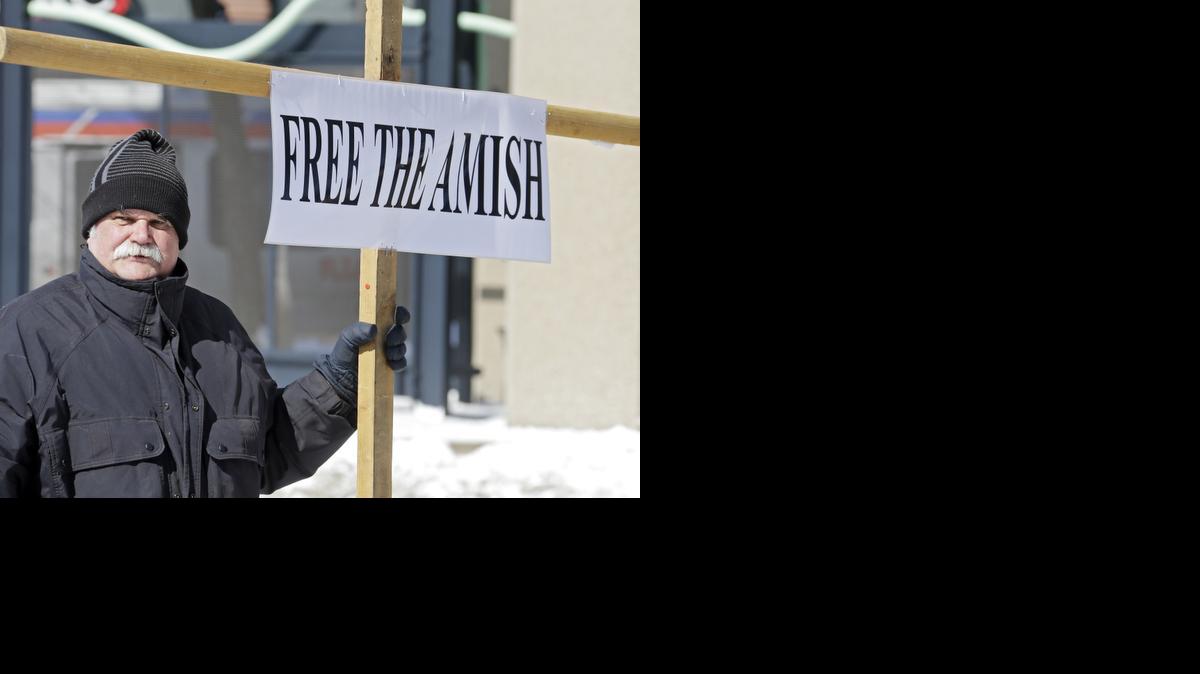 
Werner Lange holds a sign outside federal court in Cleveland, Monday, March 2, 2015. Sixteen Amish men and women were resentenced after a federal appeals court last year dismissed hate crimes convictions in the 2011 attacks in which members of a breakaway Amish community were found guilty of chopping off the beards and hair of others they disagreed with. 
