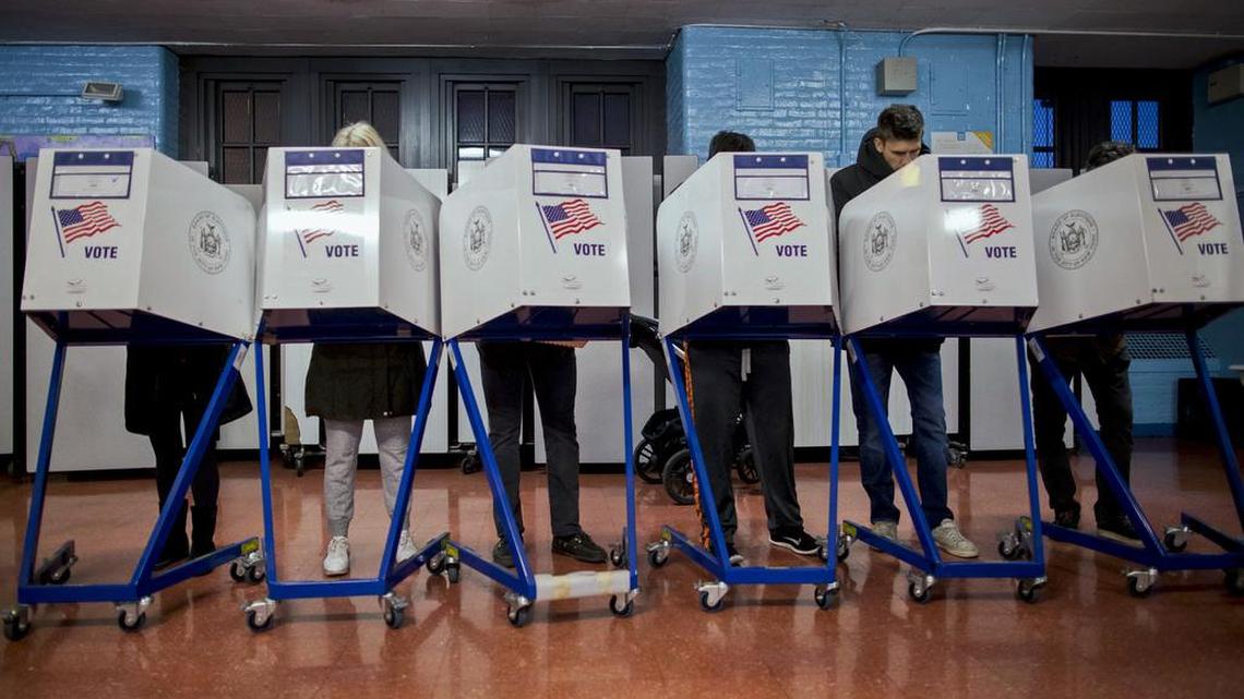 In this photo from Tuesday, Nov. 8, 2016, voters fill out their forms as they prepare to vote at a polling station in the Brooklyn borough of New York. New Yorkers will decide whether to call a constitutional convention and vote for mayor in New York City, Rochester, Buffalo and Syracuse Tuesday, Nov. 7, 2017. Voters will also cast ballots in several county races, and decide the fate of a constitutional amendment that would allow judges to strip the pensions of corrupt officials. Turnout for the off-year election is expected to be light.