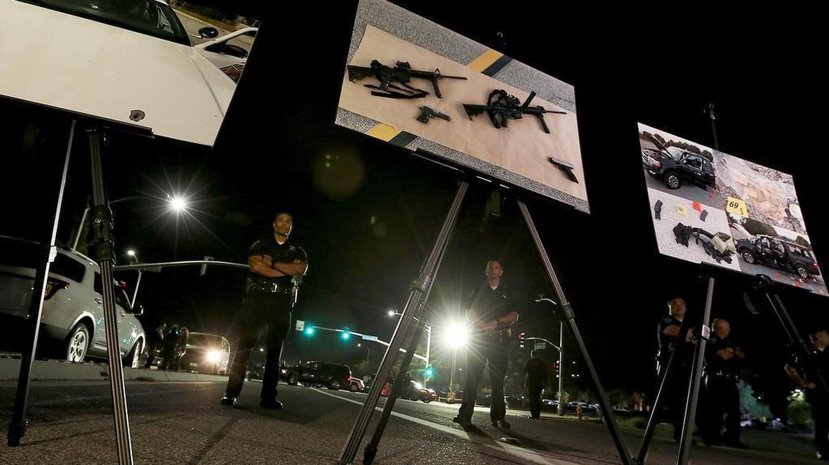 Law enforcement officials display crime scene photographs during a news briefing at the Inland Regional Center in San Bernardino, Calif., on Thursday, Dec. 3, 2015, near the scene of a mass shooting that left 14 people dead a day earlier.