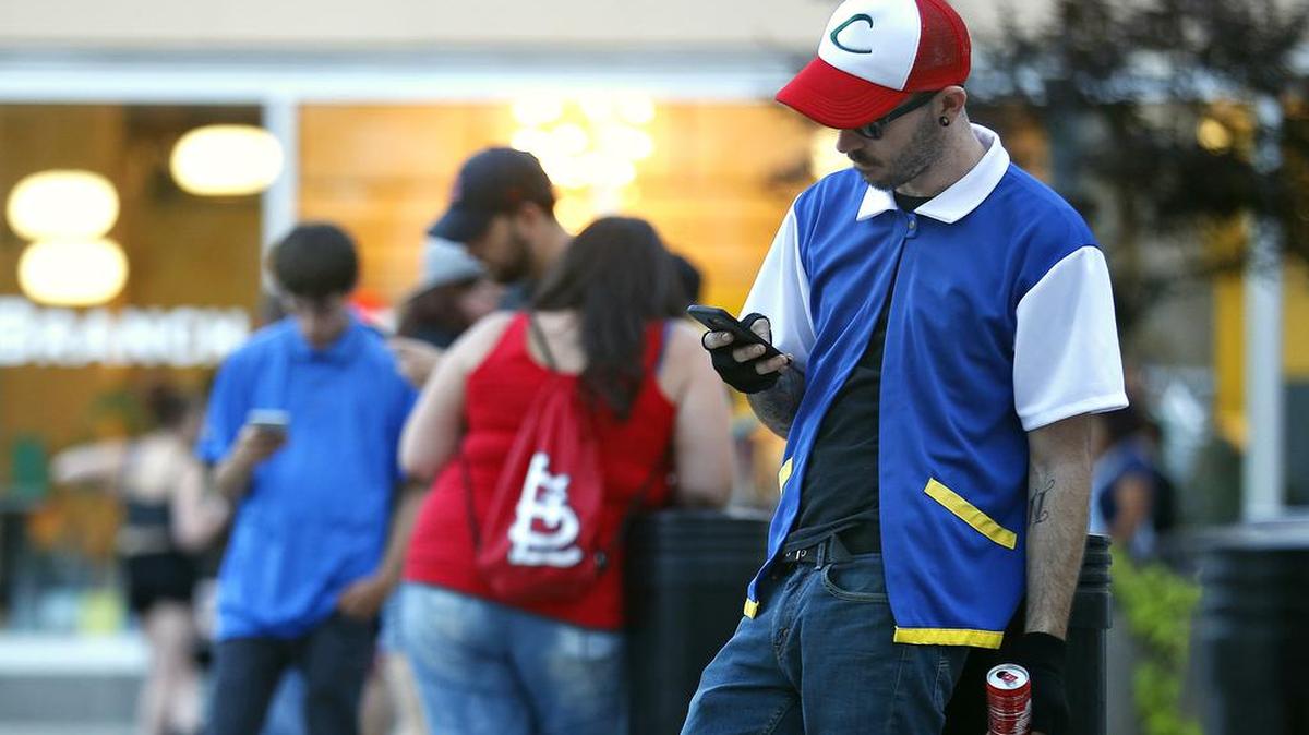 Michael Young, dressed as Pokemon character Ash Ketchum, plays “Pokemon Go” in Springfield, Mo. on Friday, July 15, 2016. Two teens playing the game in Florida got a less friendly reception from a homeowner who shot at their car after going outside to investigate a noise late at night.