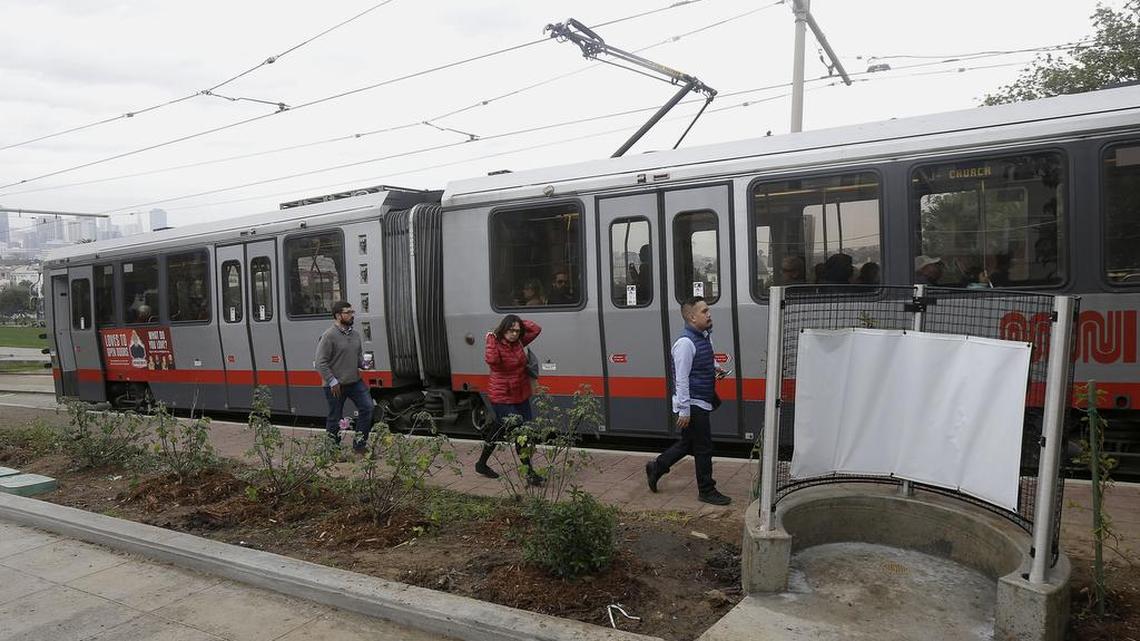 Passengers exiting a San Francisco MUNI streetcar walk past an outdoor urinal across from Dolores Park in San Francisco on Thursday. The city's iconic Dolores Park is now home to the city's first open-air urinal, the latest move to combat the destructive scourge of public urination in the City by the Bay.
