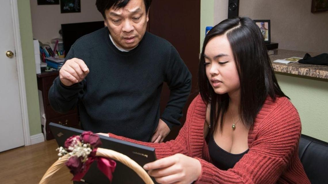 Hank Nguyen and his daughter Audrey Nguyen in their Dublin, California, home. Nguyen is among the UCSF IT workers about to lose his job.