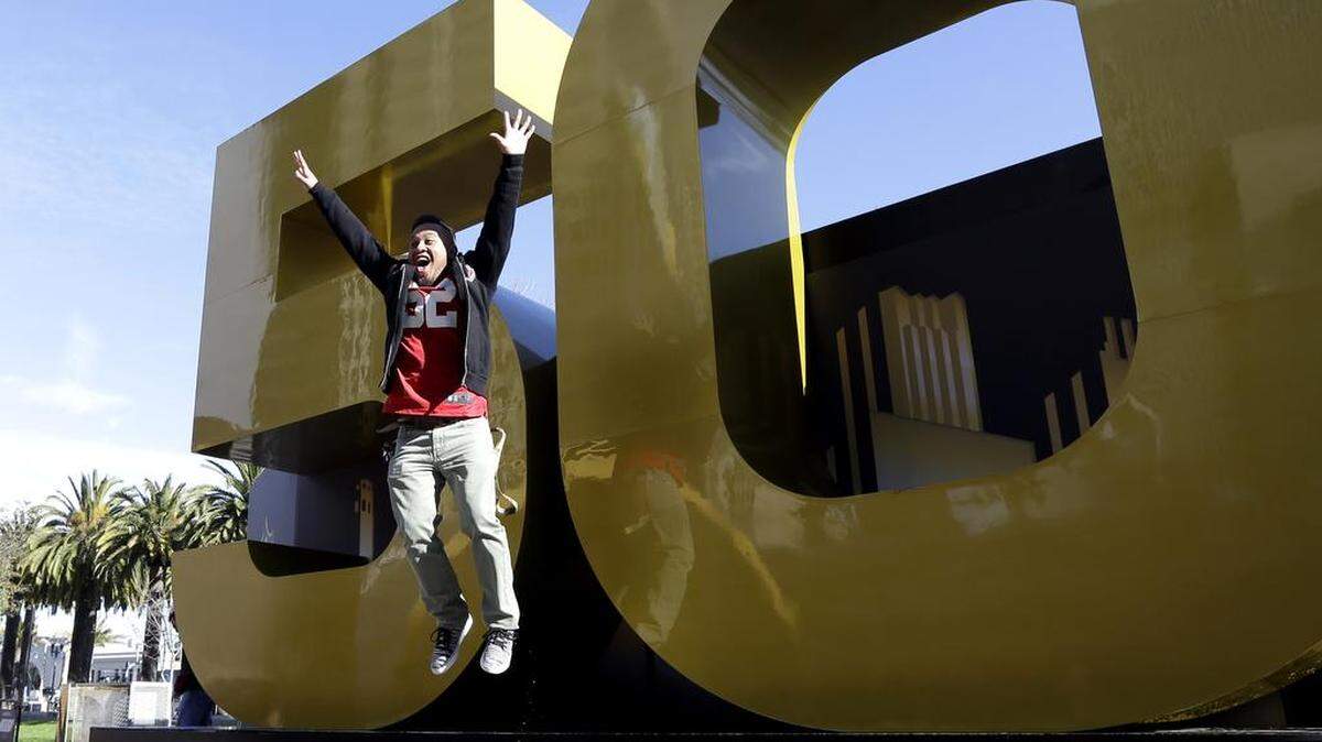 Mark Macaspac leaps off the Super Bowl 50 sign inside Super Bowl City on Saturday in San Francisco. The Denver Broncos play the Carolina Panthers in Super Bowl 50 on Sunday.