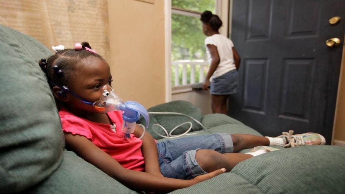 Janay Gill, 5, wears a nebulizer before heading to school in North Carolina on Friday, May 13, 2011. She suffers from chronic asthma and has to use it twice a day. Her mother Brandy Dunston enrolled her in the state’s Community Care to help afford the treatment. Community Care is a statewide network of doctors, pharmacists and care managers that work together to help keep costs down and try to squeeze more savings from treating Medicaid patients.