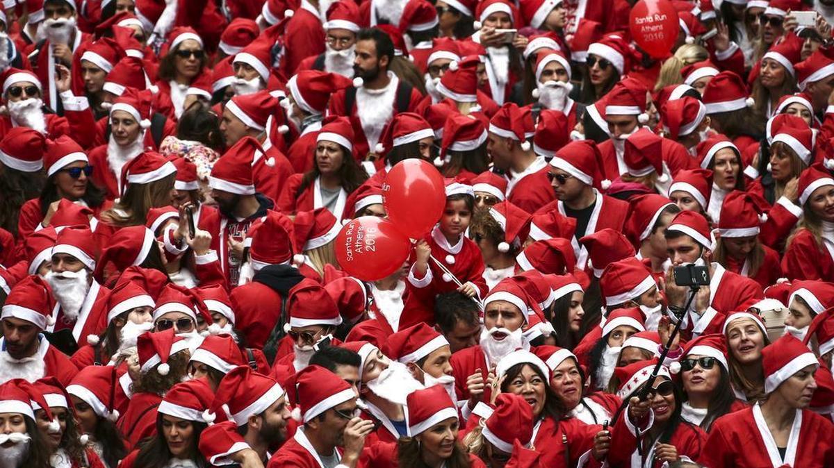People wearing Santa Claus costumes gather to take part in the 2016 Athens Santa Run in Athens, Sunday, Dec. 4, 2016. Several hundreds of people run in the charity event around the streets of central Syntagma square.