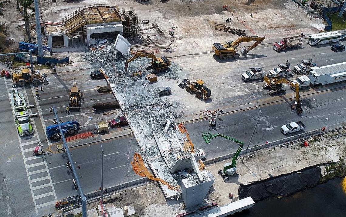 An aerial view shows the Florida International University bridge recovery operations on Saturday, March 17, 2018. The wine colored car driven by Emily Joy Panagos, its trunk crushed, is to the left of the fallen span, near the center of the frame.