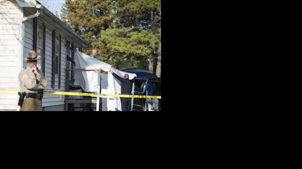 
Sheets are held as a body is removed from a residence where police say seven children and one adult have been found dead Monday, April 6, 2015, in Princess Anne, Md. 
