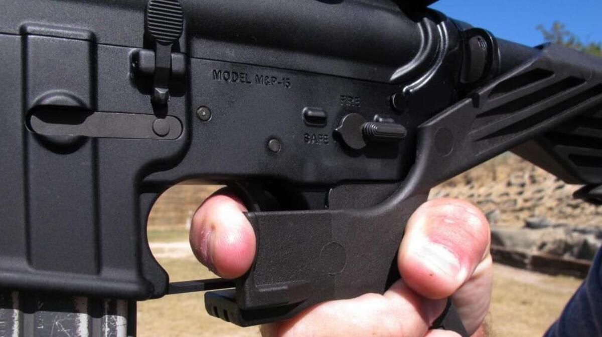 Shooting instructor Frankie McRae demonstrates the grip on an AR-15 rifle fitted with a bump stock at his 37 PSR Gun Club in Bunnlevel, N.C.