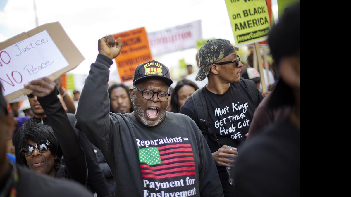
Demonstrators march to City Hall in Baltimore on Saturday, May 2, 2015, the day after charges were announced against the six police officers involved in Freddie Gray's death.
