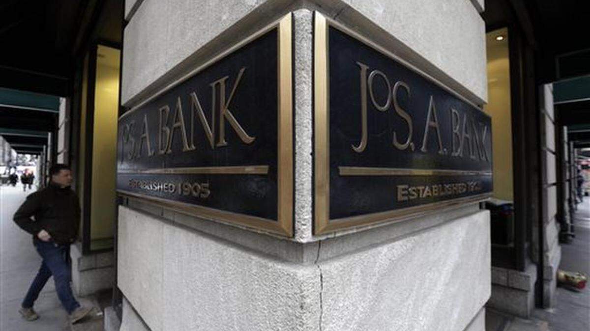 FILE - In this Monday, March 3, 2014, file photo, a man enters a Jos. A. Bank store, in New York. Men’s Wearhouse is still trying to figure out the best strategy for its business since buying rival Jos. A. Bank, but needs to move quickly as its struggles continue. The men’s clothing retailer reported Thursday, Dec. 10, 2015, that sales at Jos. A Bank locations open at least a year tumbled 14.6 percent in the third quarter as fewer customers visited those shops.