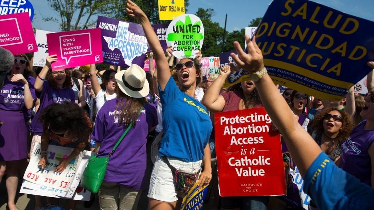 Stephanie Castro, center, celebrates during a rally at the Supreme Court in Washington, Monday, June 27, 2016, after the court struck down Texas' widely replicated regulation of abortion clinics.