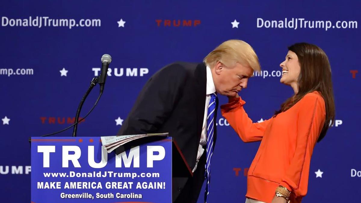 
Donald Trump supporter Mary Margaret Bannister checks to see if his hair is real during his speech at the TD Convention Center, Thursday, Aug, 27, 2015, in Greenville, S.C. Trump says his trademark hairdo is for real. He told 1,800 people in South Carolina Thursday: “It’s my hair ... I swear.” 
