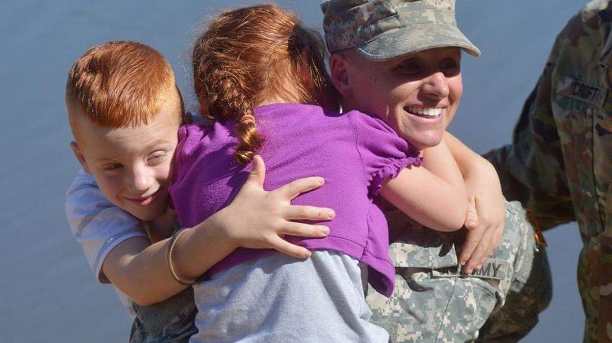 U.S. Army Maj. Lisa Jaster is congratulated by her children after graduating from the Army’s Ranger School at Fort Benning, Ga., last October; she will be President Obama’s guest at the upcoming State of the Union address.