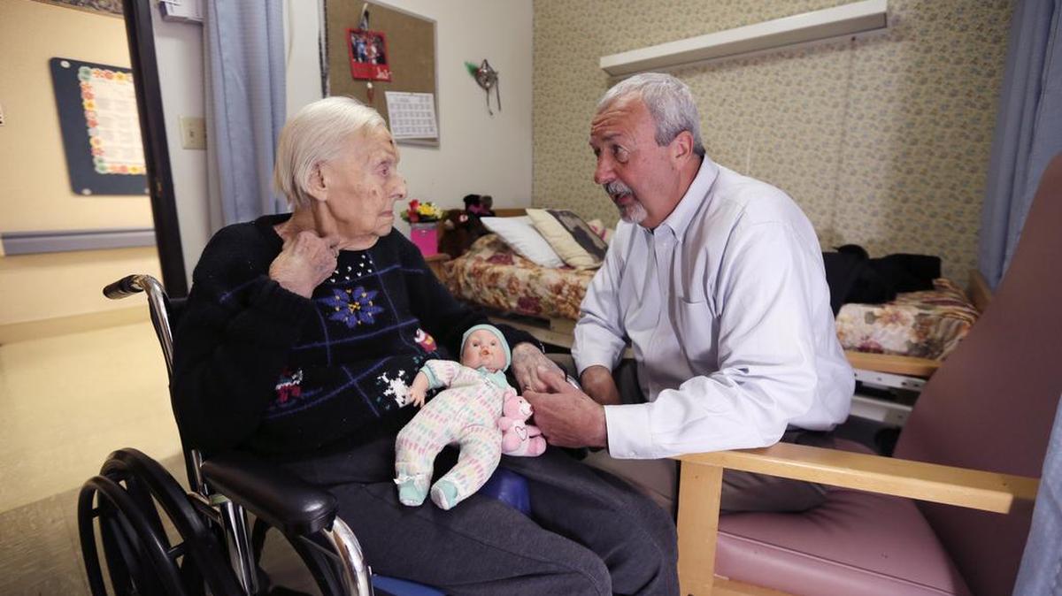 Phyllis Hotchkiss talks to her son, Glen Hotchkiss, at her nursing home in Adrian, Mich. Phyllis, 93, who has dementia and is confined to a wheelchair, was involuntarily discharged from her nursing home earlier in the year, to one farther away from her family.