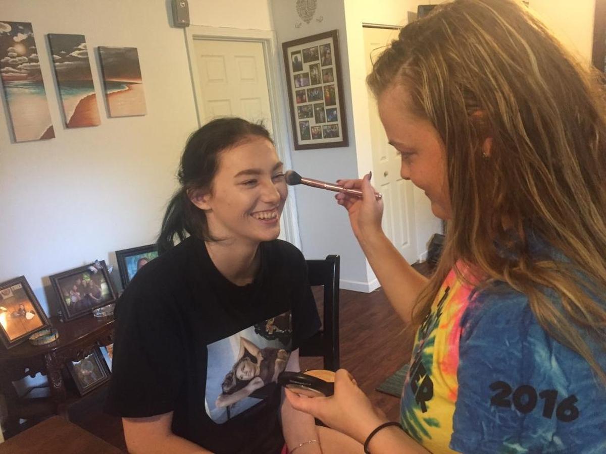 Hayley Illig, 17, has her makeup done by her cousin, Mackenzie Hamann, at Hayley’s home in Cahokia. They are trying out some of the new MAC products Hayley bought while on her Make-A-Wish-sponsored Los Angeles shopping trip.