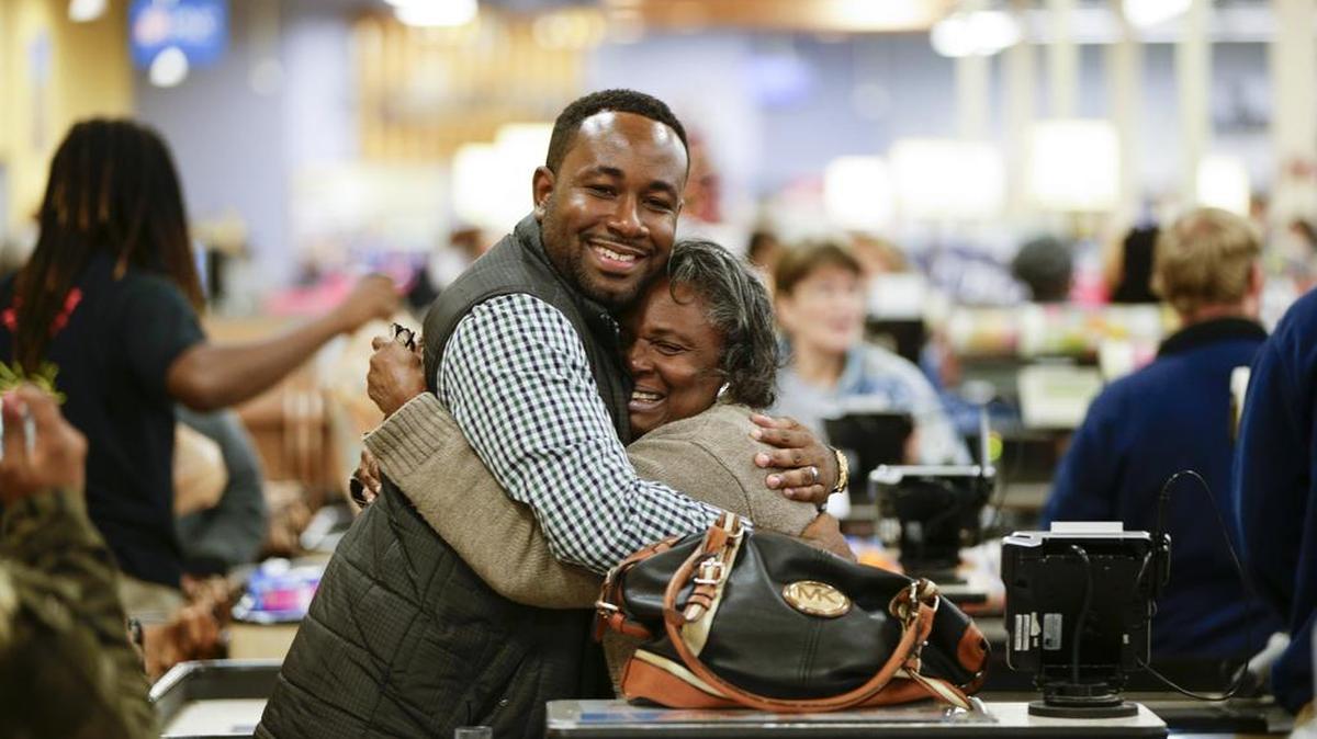 Erma Mack hugged LaRon Tanksley after his church, Perfecting Praise, paid $50 toward her Kroger bill as a gesture of kindness on Monday evening.