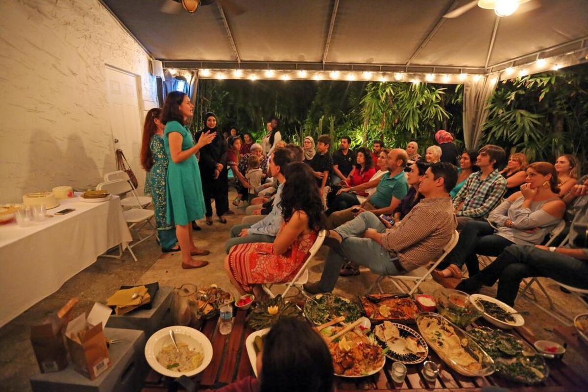 Supper club organizer Kate Cruz thanks the participants who helped with the supper club that raises funds for Syrian refugees in the South Florida community on April 22.