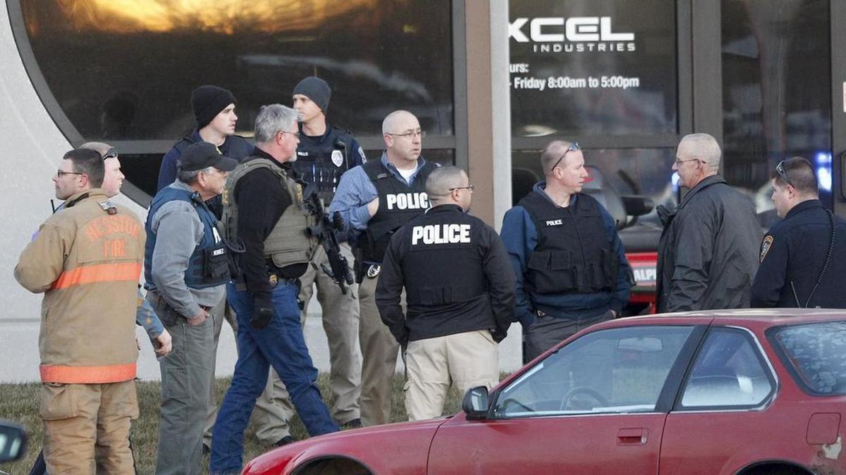 Police guard the front door of Excel Industries, where a gunman killed several people and injured more, in Hesston, Kan., Wednesday. (Feb. 25, 2016)
