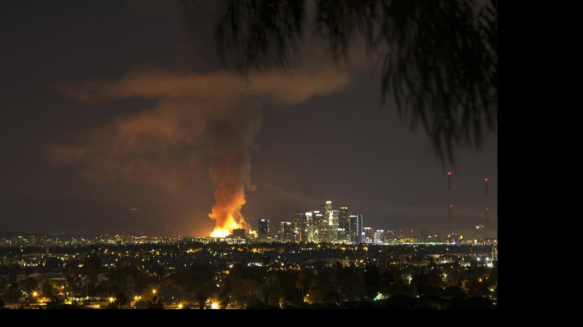 
A fire engulfs an apartment building construction site near downtown Los Angeles on Dec. 8. A man has been arrested on suspicion of setting two large fires that day.
