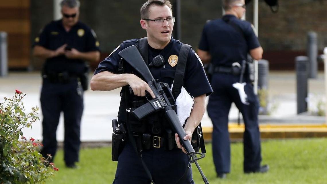 Police guard the emergency room entrance of Our Lady Of The Lake Medical Center, where wounded officers were brought, in Baton Rouge, La., Sunday, July 17, 2016.