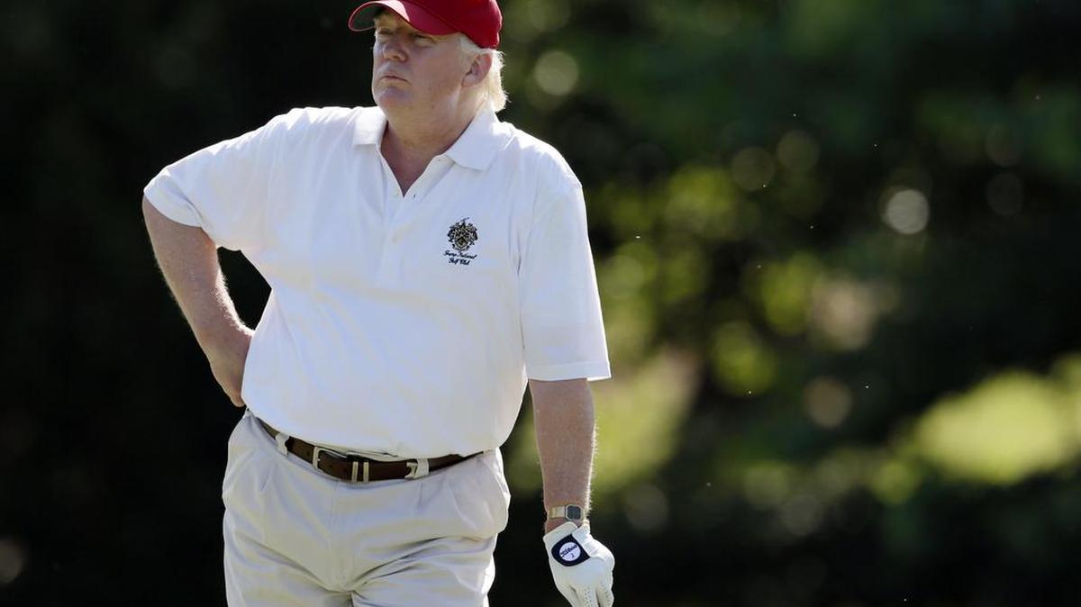 In this June 27, 2012, file photo, Donald Trump stands on the 14th fairway during a pro-am round of the AT&T National golf tournament at Congressional Country Club in Bethesda, Md. The American developer wants to build a seawall to protect his golf course in Ireland from the effects of climate change. (AP Photo/Patrick Semansky, File)