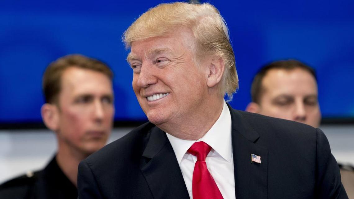 President Donald Trump smiles while participating in a roundtable at the Customs and Border Protection National Targeting Center in Reston, Va., Friday, Feb. 2.