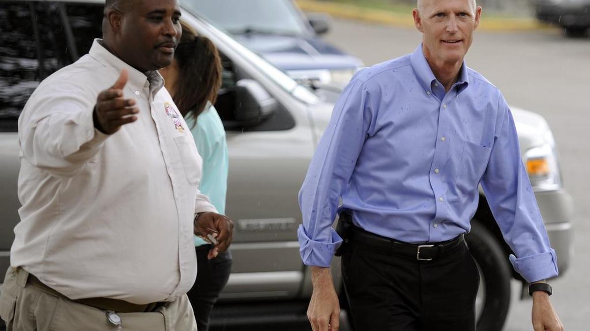 
Gov. Rick Scott, right, is greeted by Hillsborough County Emergency Operations Center Manager Preston Cook in Tampa, Fla. on Friday, Aug. 28, 2015. 
