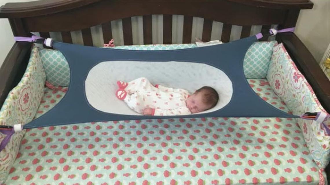 The Crescent Womb Safety Bed suspends infants in mesh.