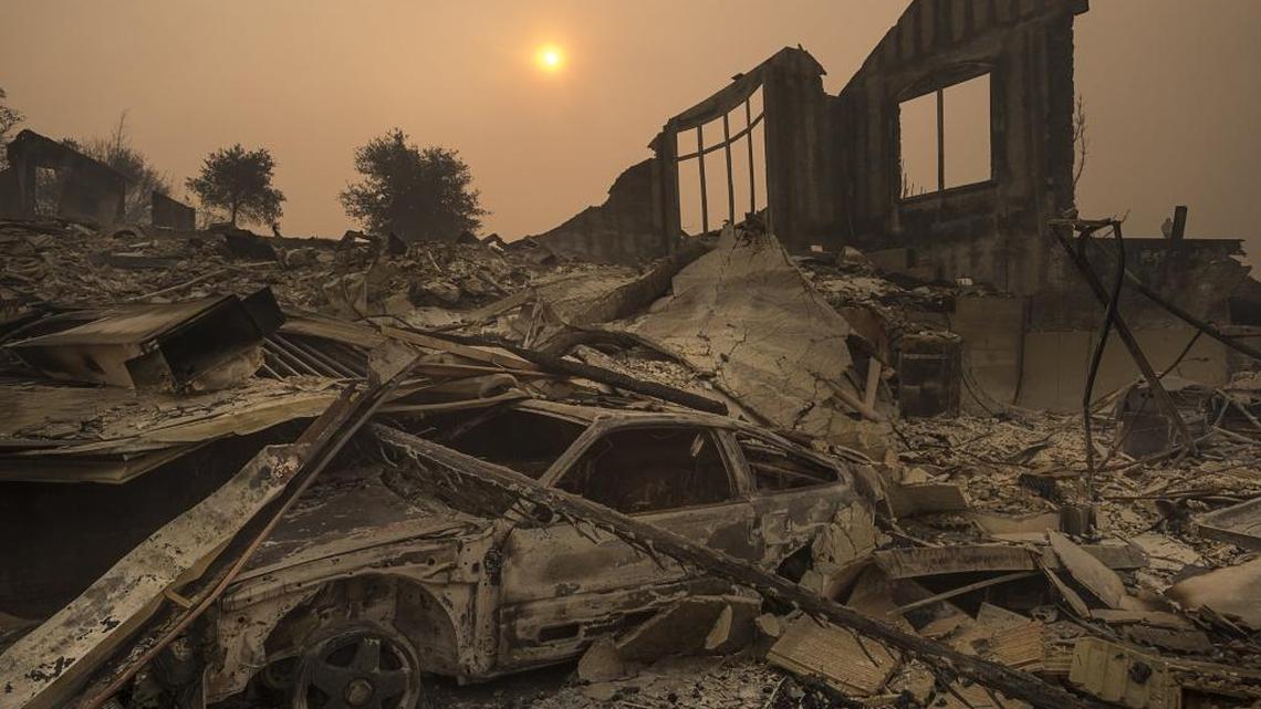 The sun rises through a cloud of smoke in the Rincon Ridge area after a Sonoma County wildfire on Tuesday October 10, 2017 in Santa Rosa, Calif. Scientists say climate change is producing more intense heat waves, like those seen this summer in California, drying out vegetation and adding to the risk of explosive blazes.