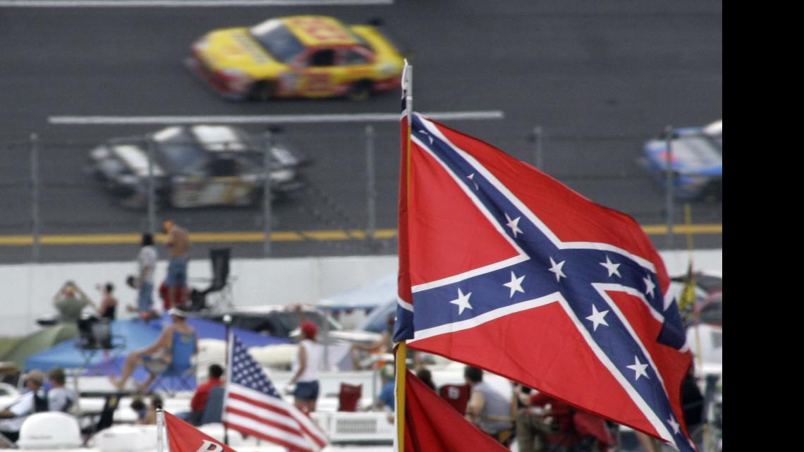 
In this Oct. 7, 2007, file photo, a Confederate flags fly in the infield as cars come out of turn one during a NASCAR auto race at Talladega Superspeedway in Talladega, Ala. NASCAR is backing South Carolina Gov. Nikki Haley's call to remove the Confederate flag from the South Carolina Statehouse grounds in the wake of a massacre at a Charleston church, it said in a statement Tuesday, June 23, 2015. Though NASCAR bars the use of the flag in any official capacity, many fans fly the flag at their races. 
