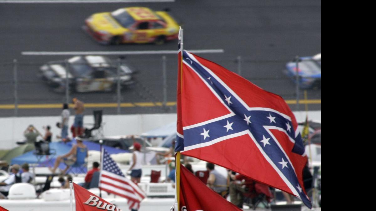 
In this Oct. 7, 2007, file photo, a Confederate flags fly in the infield as cars come out of turn one during a NASCAR auto race at Talladega Superspeedway in Talladega, Ala. NASCAR is backing South Carolina Gov. Nikki Haley's call to remove the Confederate flag from the South Carolina Statehouse grounds in the wake of a massacre at a Charleston church, it said in a statement Tuesday, June 23, 2015. Though NASCAR bars the use of the flag in any official capacity, many fans fly the flag at their races. 

