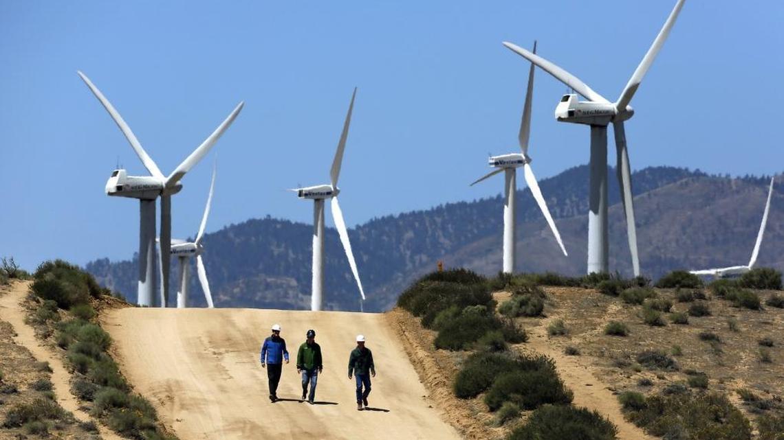 Gregory Wetstone, from left, Randy Hoyle and Kevin Martin of Terra-Gen Power walk past the Alta East wind energy project in the Tehachapi Mountains.