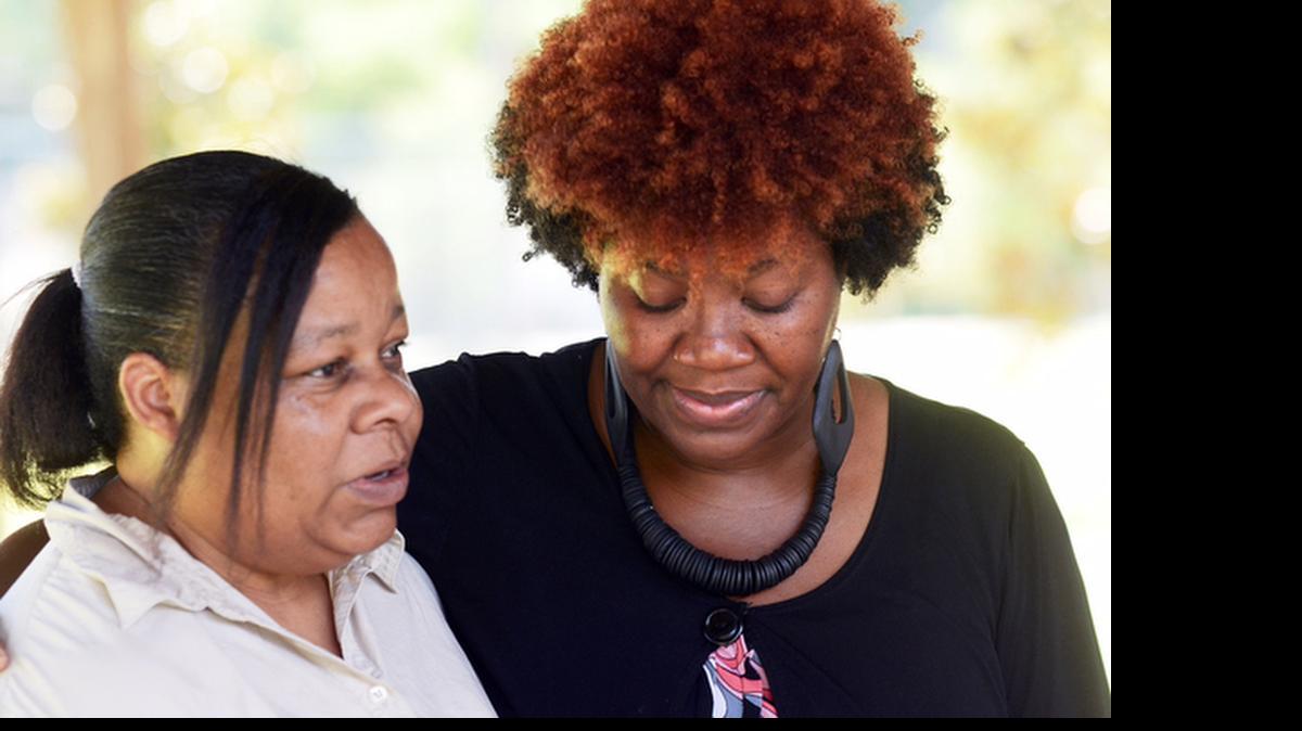 
Biner Lawyer-Green, left, of Robertsville, S.C., and Topeka Williams, of Hardeeville, console each other during a special Prayer in the Park service at Harold Turpin Park on Thursday in Ridgeland, S.C. The service was held for the nine victims of Wednesday’s shooting at Charleston’s Emanuel African Methodist Episcopal Church, which included the church’s pastor Clementa Pinckney, who was also a state senator from Ridgeland. Both Lawyer-Green and Williams attended high school with Pinckney. “I couldn’t believe it,” said Williams of the news. “It doesn’t seem real ... we’ve got to come together,” said Lawyer-Green.
