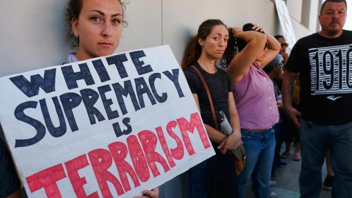 A demonstrators carrying signs protesting racism in Los Angeles last August, when many rallied to condemn racism in the wake of the deadly events in Charlottesville, Va.