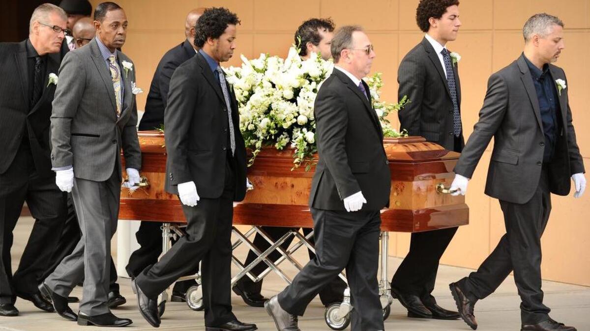 The casket of singer Natalie Cole is carried out of the West Los Angeles Church of God during funeral services on Monday.