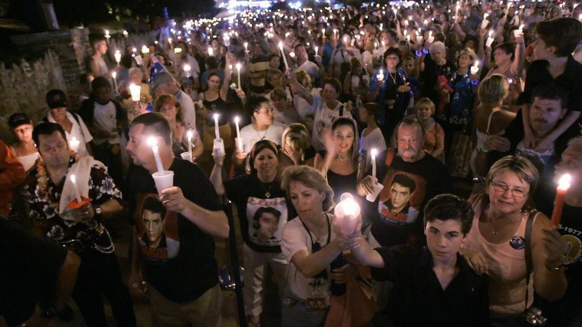 Elvis Presley fans take part in a candlelight ceremony outside the walls of Graceland, Presley’s Memphis home, marking the 30th anniversary of the death of Presley in Memphis, Tenn., on Wednesday, Aug. 15, 2007. Presley died Aug. 16, 1977.