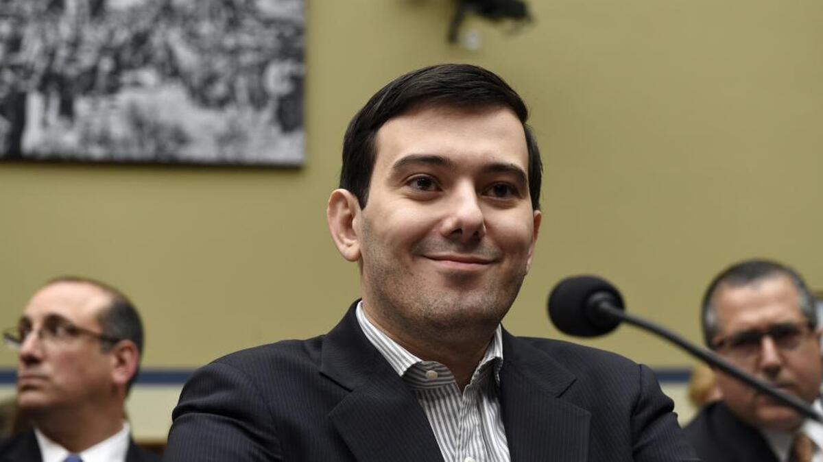 Pharmaceutical chief Martin Shkreli listens on Capitol Hill in Washington on Thursday during the House Committee on Oversight and Reform Committee hearing on his former company's decision to raise the price of a lifesaving medicine. Shkreli refused to testify before U.S. lawmakers who excoriated him over severe hikes for a drug sold by a company that he acquired.