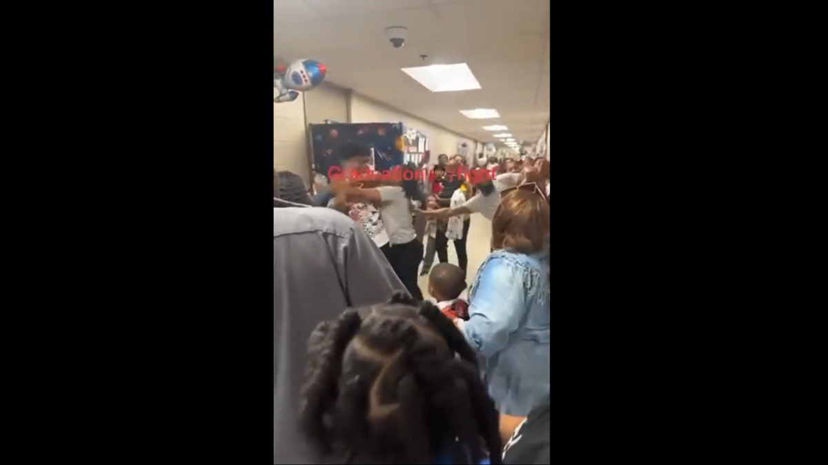 Video shows adults fight in a hallway at an Arkansas elementary school during a class graduation.